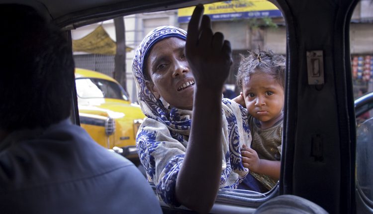 A street beggar gets into the car, Calcutta Kolkata India